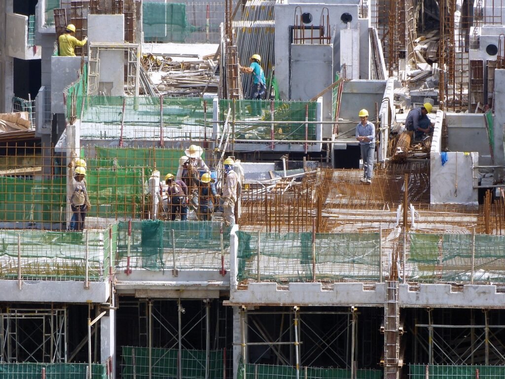 Construction crew and developers working on property development site, transforming acquired land into high-quality housing projects.